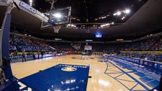The referee fell to the ground and was injured during a women's basketball brawl between South Alabama and Coastal Carolina.