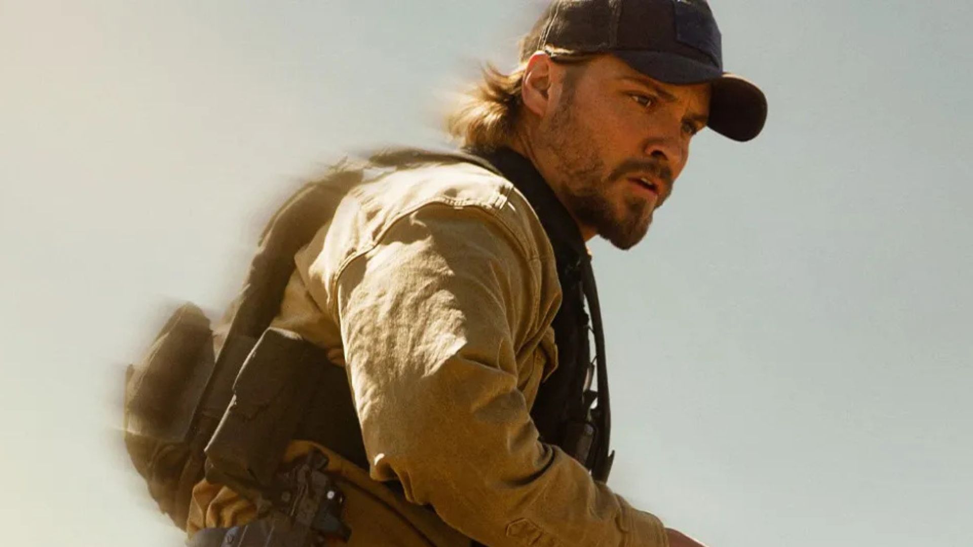 Luke Grimes is watching something off-screen