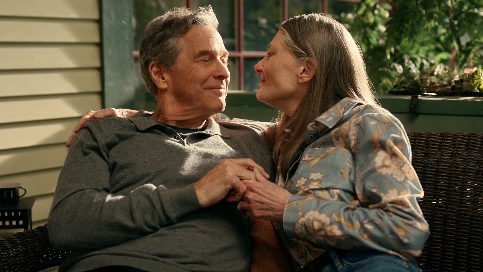 Doc and Hope kiss on their porch bench