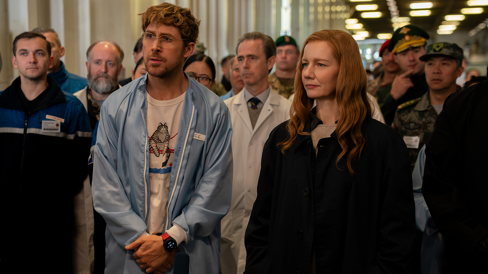 Ryland Grace and Eva Stratt watch an experiment with a group of people as part of the Hail Mary Project