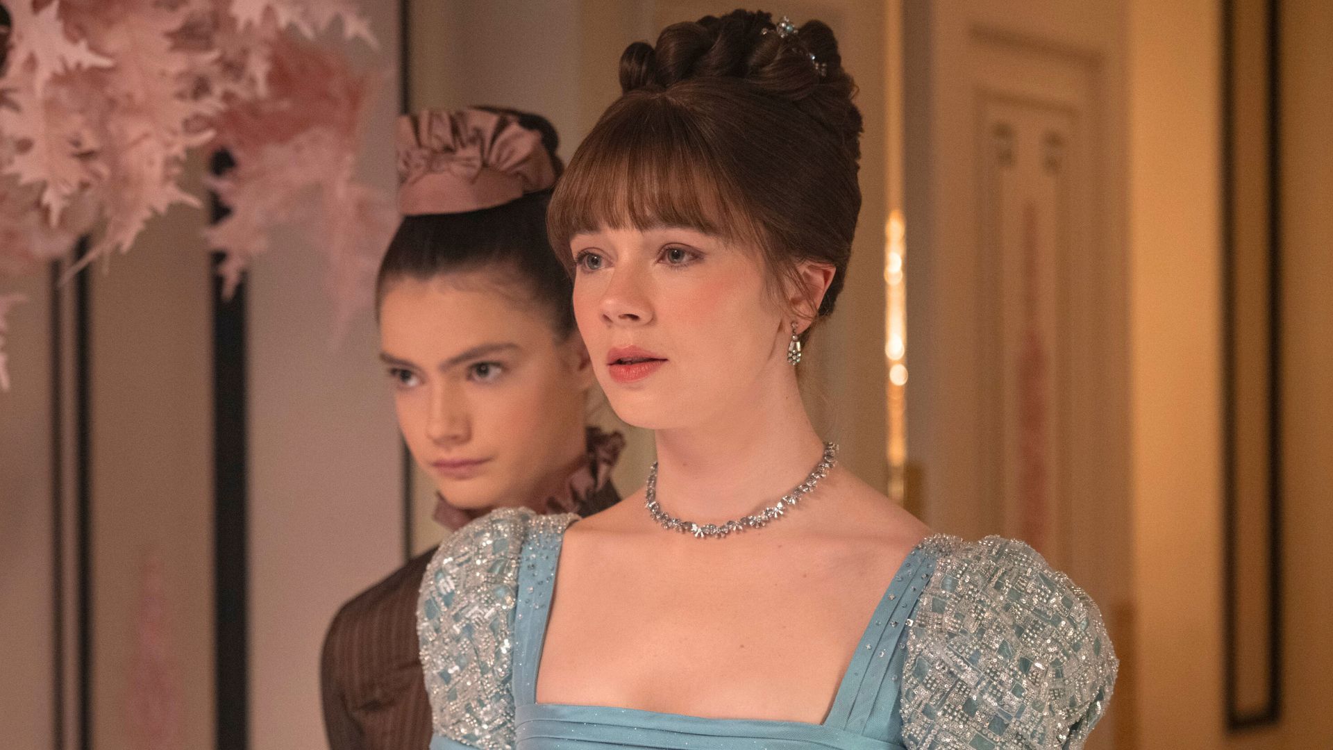 Hyacinthe places her chin on Eloise's shoulder