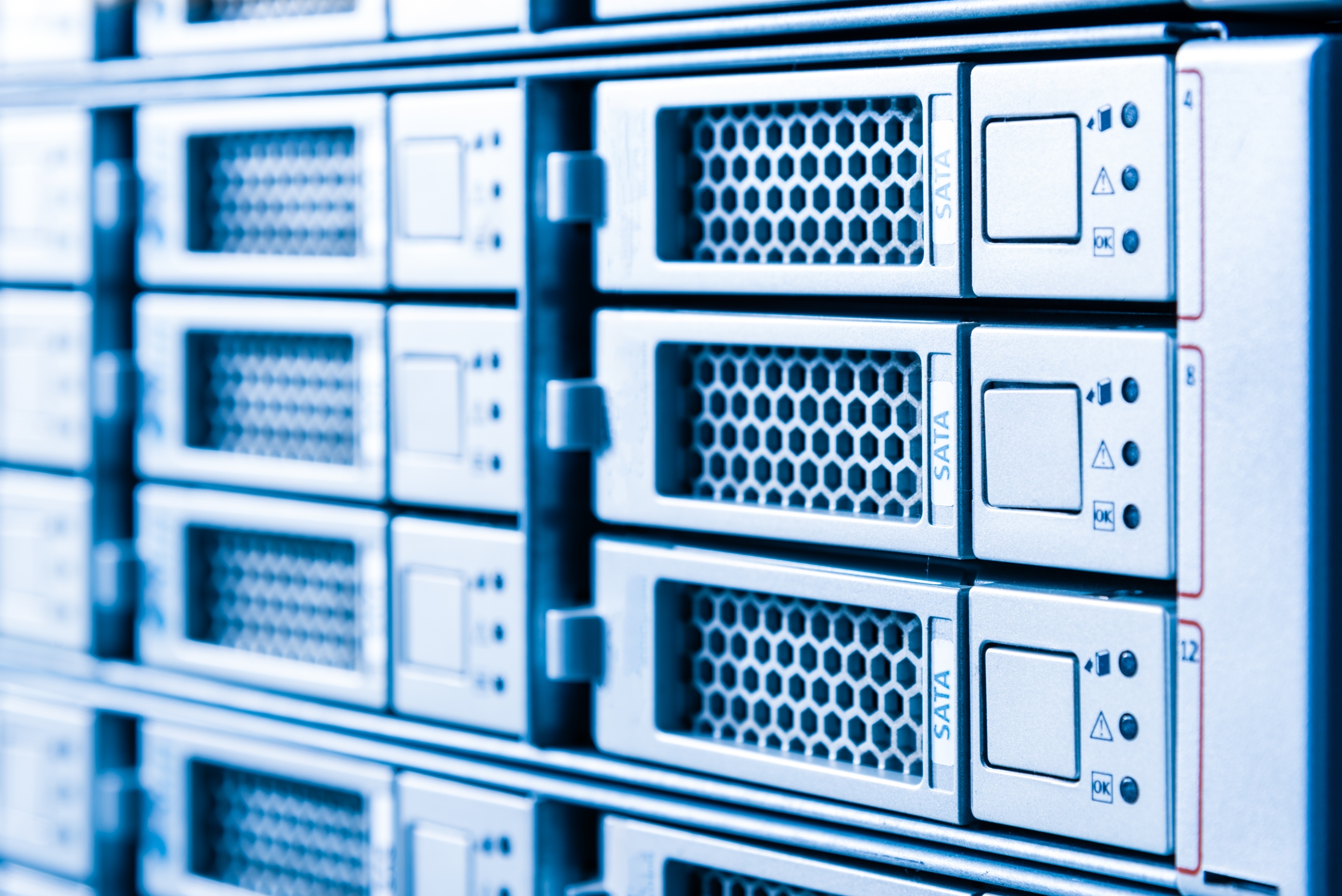 Row of hard drives serving as data storage in server room