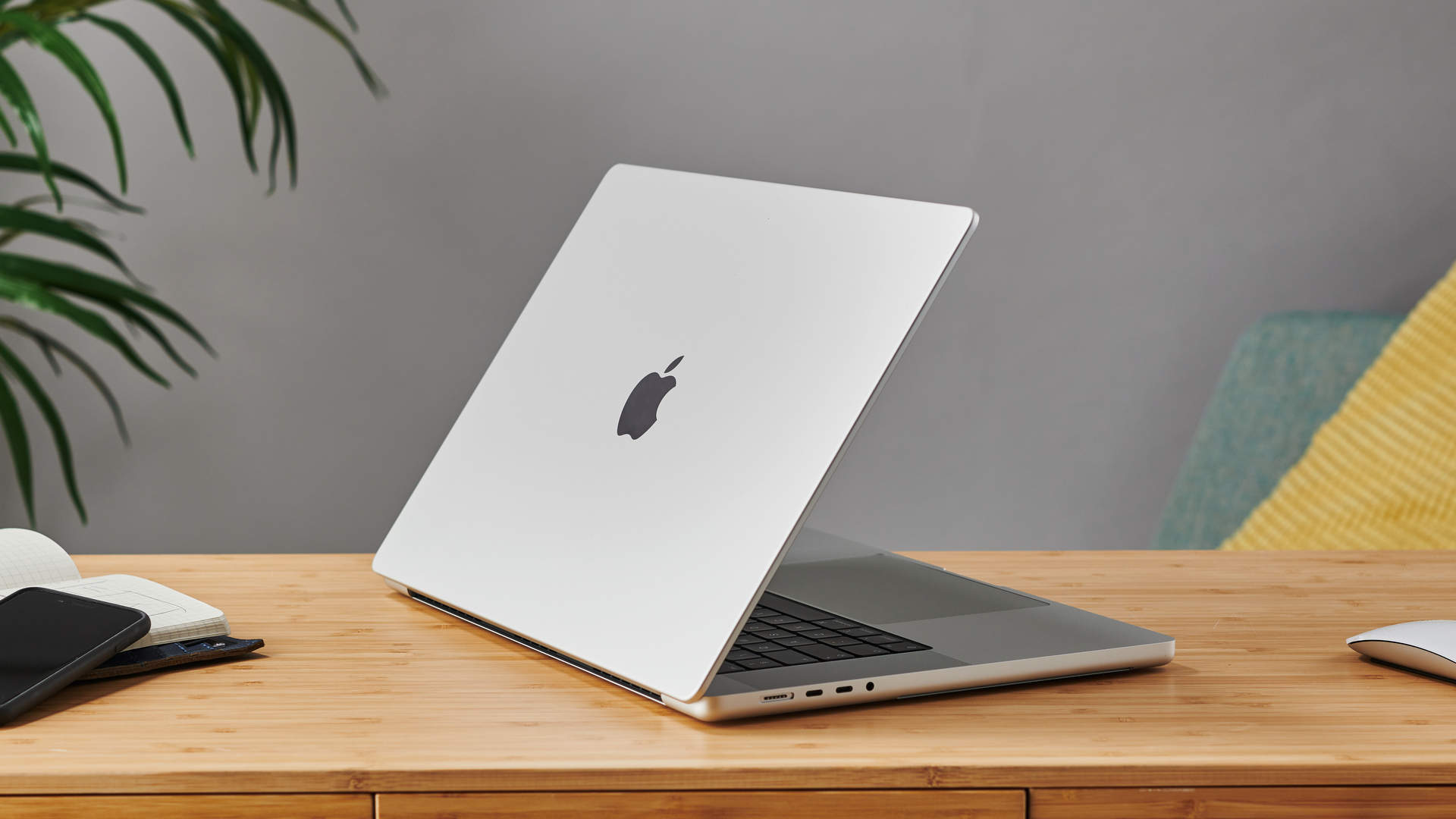 16-inch MacBook Pro on wooden table in modern office