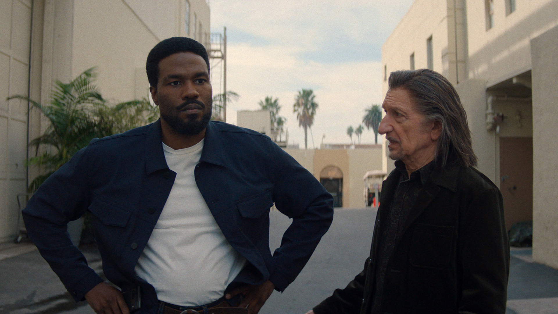 Simon Williams standing with his hands on his hips as Trevor Slattery looks on in Marvel's Wonder Man