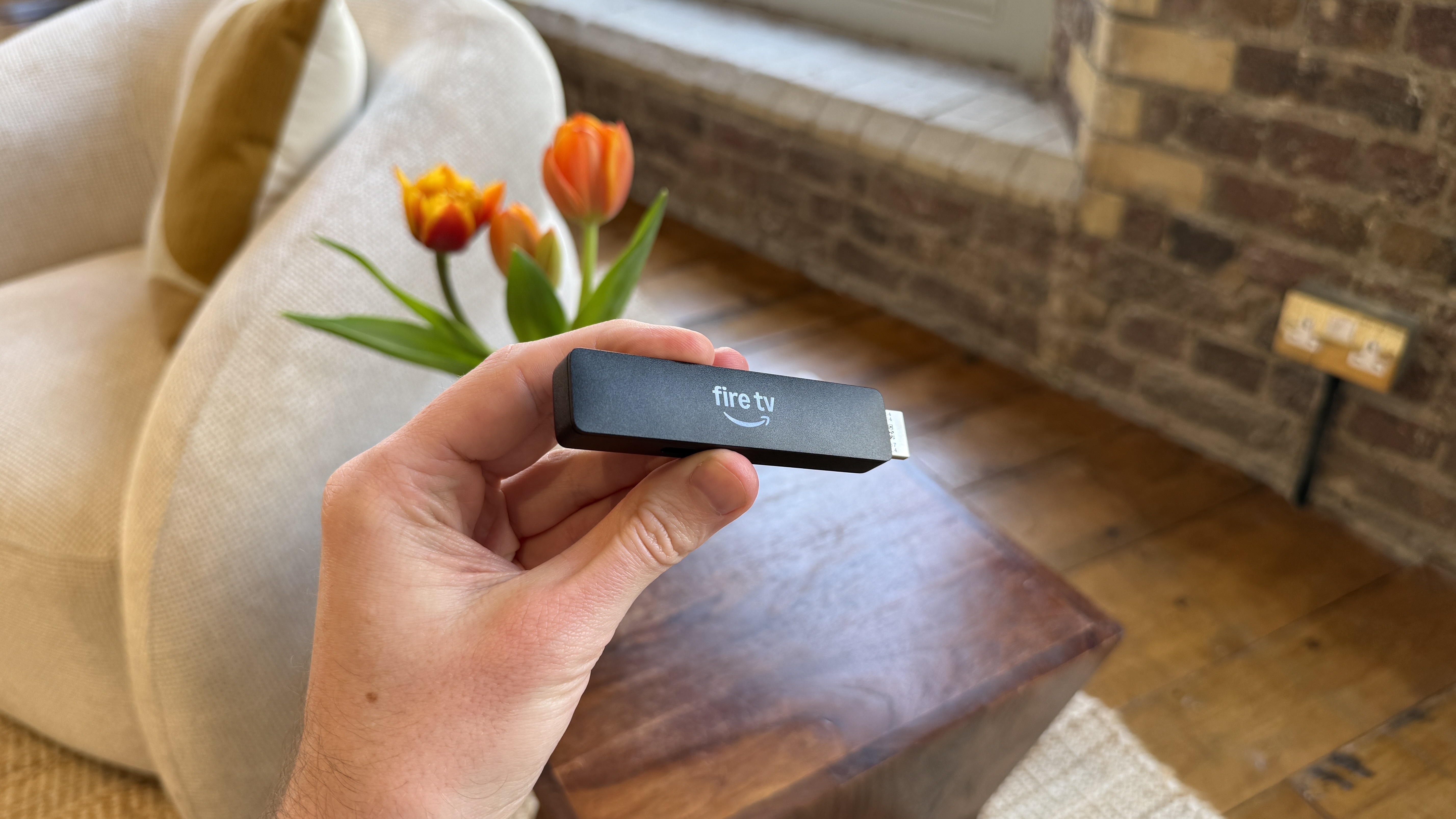 Amazon Fire TV Stick HD held in a person's hand