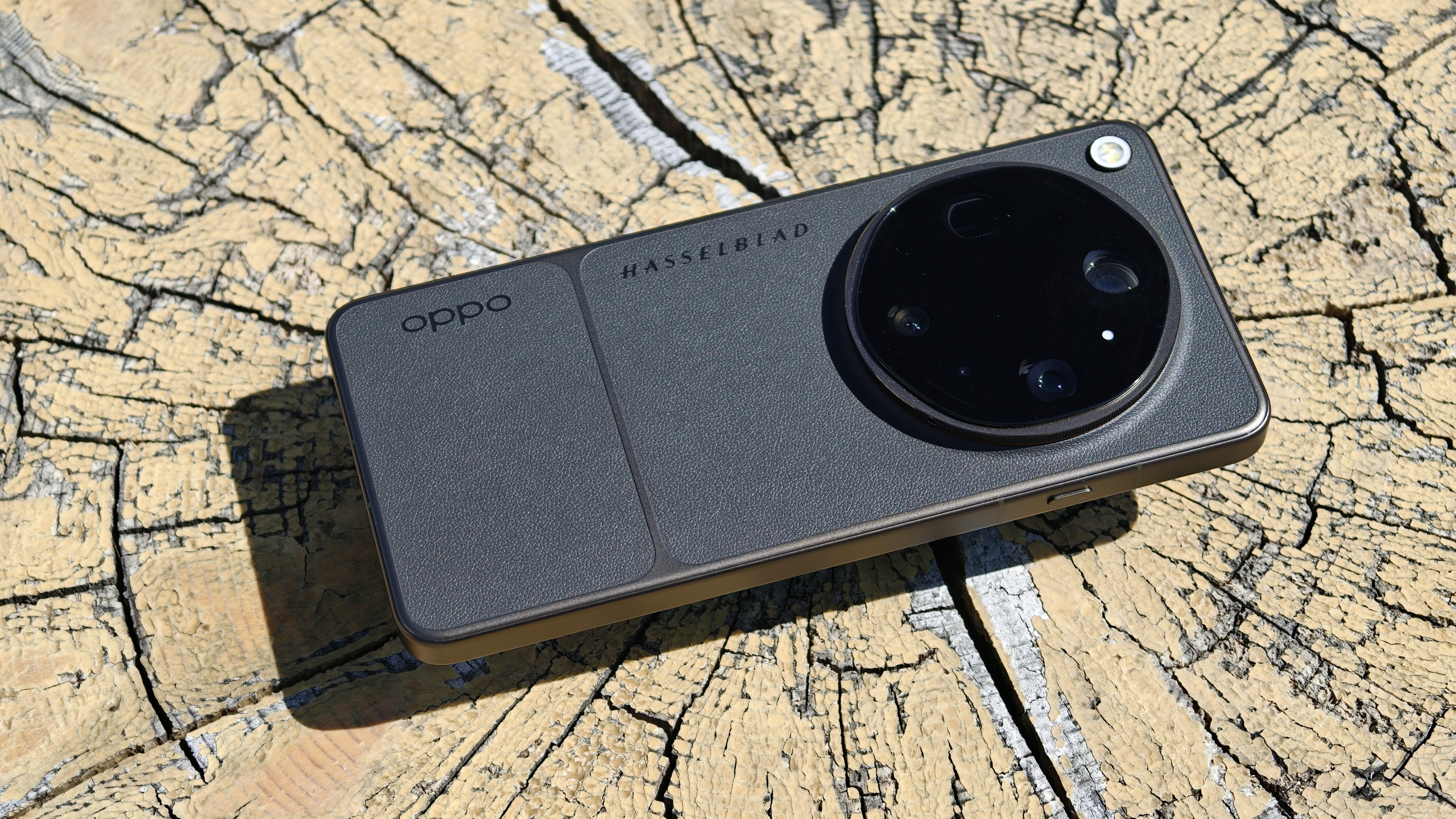 Oppo Find X9 Ultra phone on cracked wooden surface