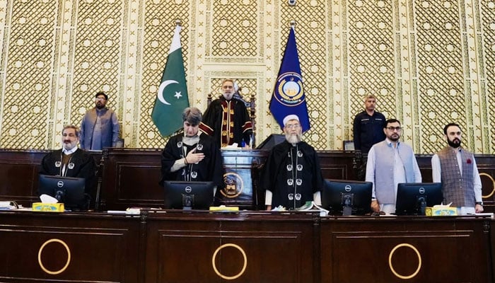 KP Assembly Speaker (center) sings the national anthem before presiding over the session on April 13, 2026. — Facebook/@pakpgov