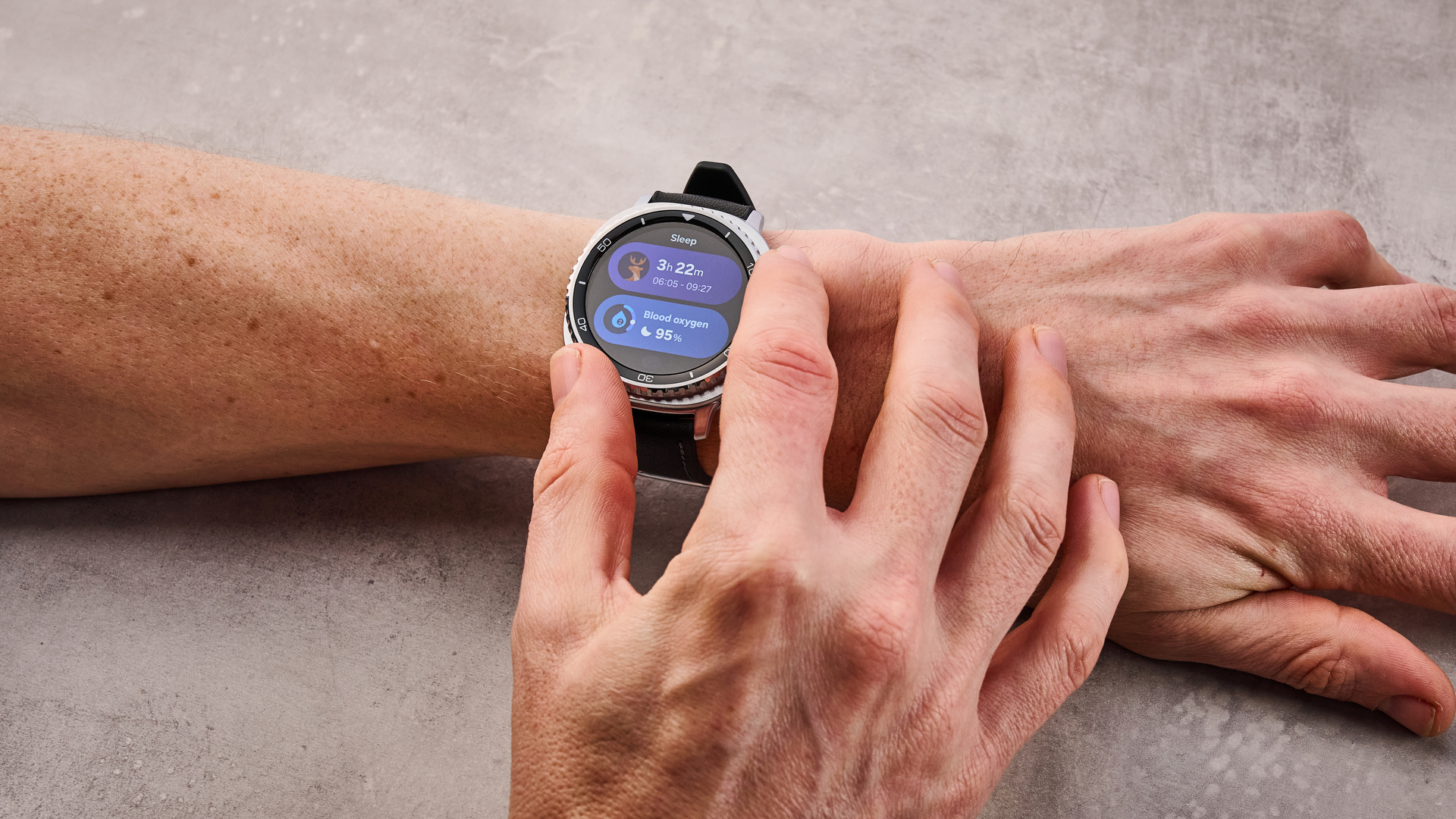The Samsung Galaxy Watch 8 Classic on a man's wrist; he turns his dial to select his sleep functions.
