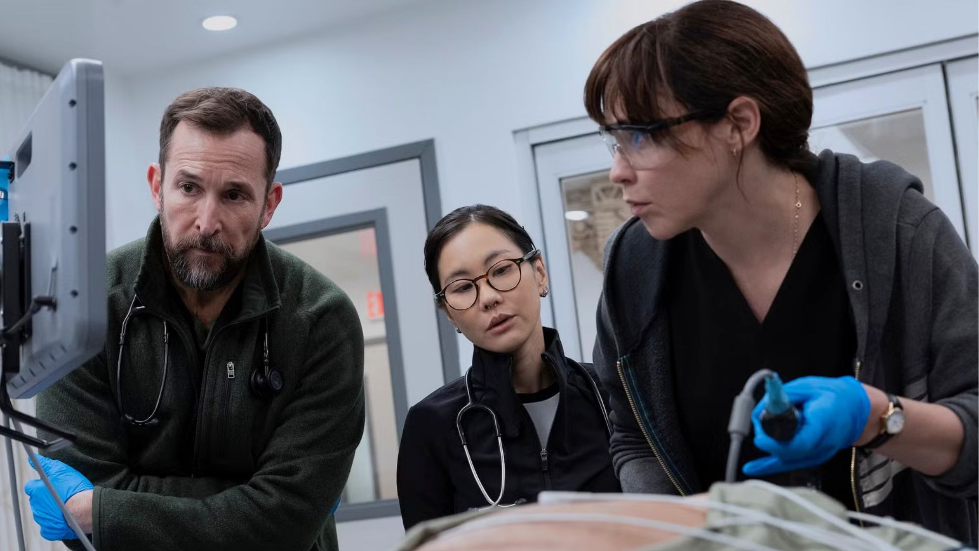 A team of doctors operates on a torso