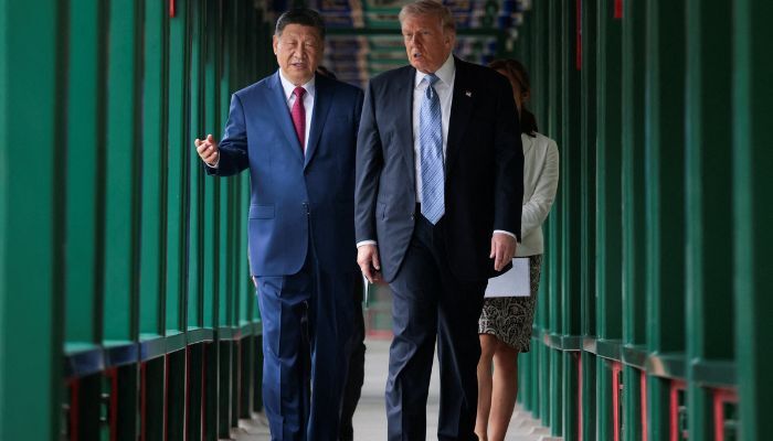 U.S. President Donald Trump takes part in a friendship walk in Zhongnanhai Garden with Chinese President Xi Jinping in Beijing, China, May 15, 2026. — Reuters