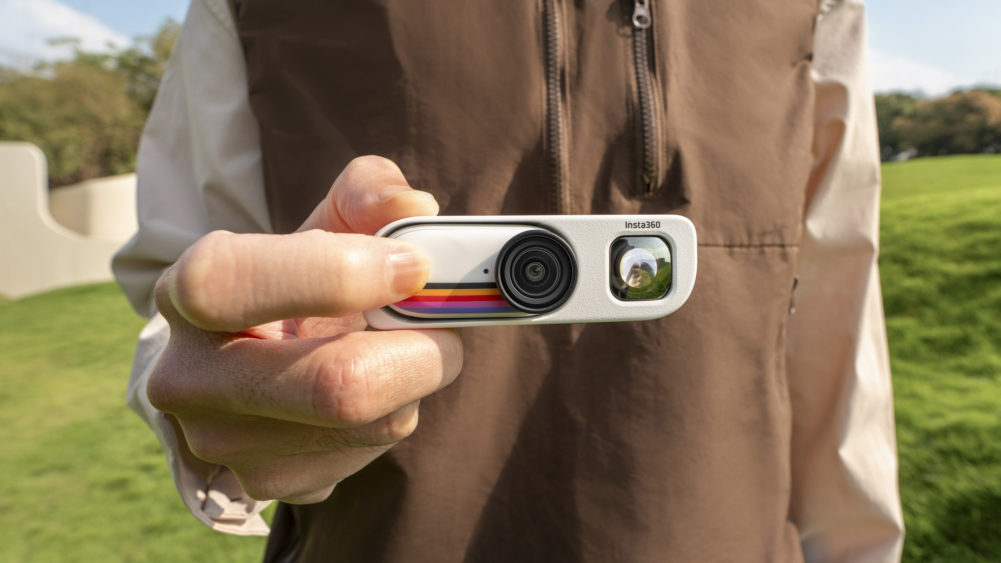 Insta360 Go 3S Retro Edition, with the thumb-sized action camera slotted into the Retro Bundle's viewfinder housing, held by a user