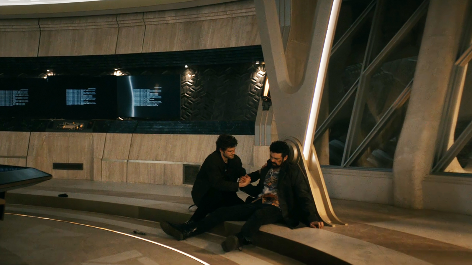 A wide shot of Hughie holding hands with a dead butcher in Vought Tower during the Season 5 finale of The Boys.