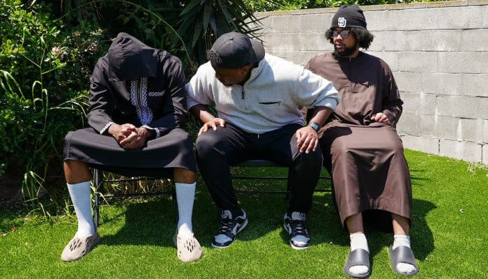Jibril Abdullah, Mohammed Abdullah and Khalid Abdullah, sons of security guard Amin Abdullah, killed in a shooting, sit outside their home in San Diego, California, United States, May 20, 2026. — Reuters