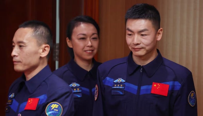 Astronauts Zhu Yangzhu, Zhang Zhiyuan and Lai Ka-ying, who is Hong Kong's first astronaut, walk to attend a press conference ahead of the Shenzhou-23 spaceflight mission to China's Tiangong space station, at the Jiuquan Satellite Launch Center near Jiuquan, Gansu province, China, May 23, 2026. — Reuters