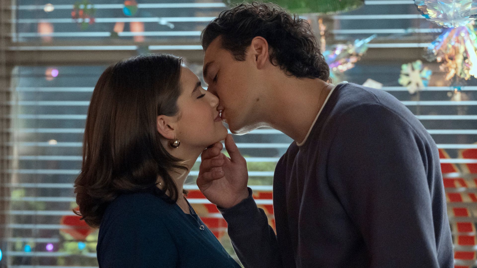 A young couple kisses