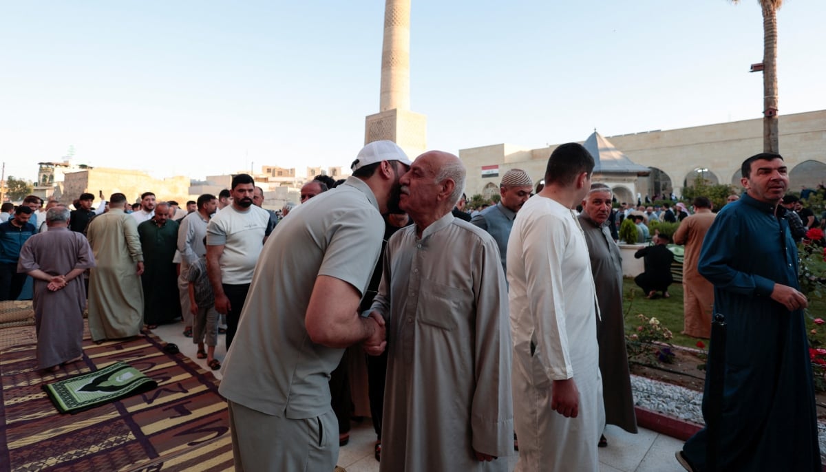 Muslims exchange greetings after the Eid ul Adha prayer, in Mosul, Iraq, May 27, 2026. — Reuters