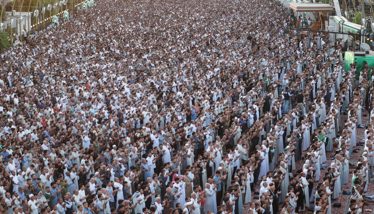 Muslim worshipers perform Eid ul Adha prayers between the shrines of Imam Hussein and Imam Abbas in the holy city of Karbala, Iraq, May 27, 2026. — Reuters