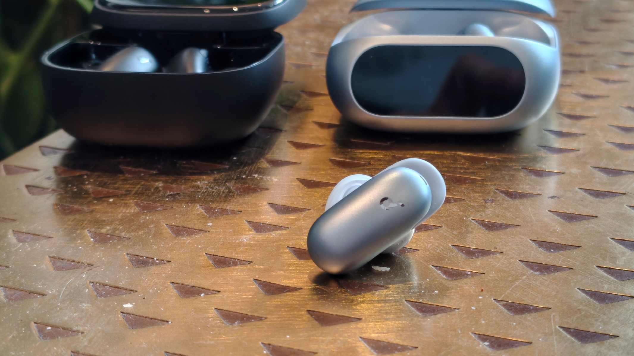 The Anker Soundcore Liberty 5 Pro earphone next to its case and the Anker Soundcore Liberty 5 Pro Max.