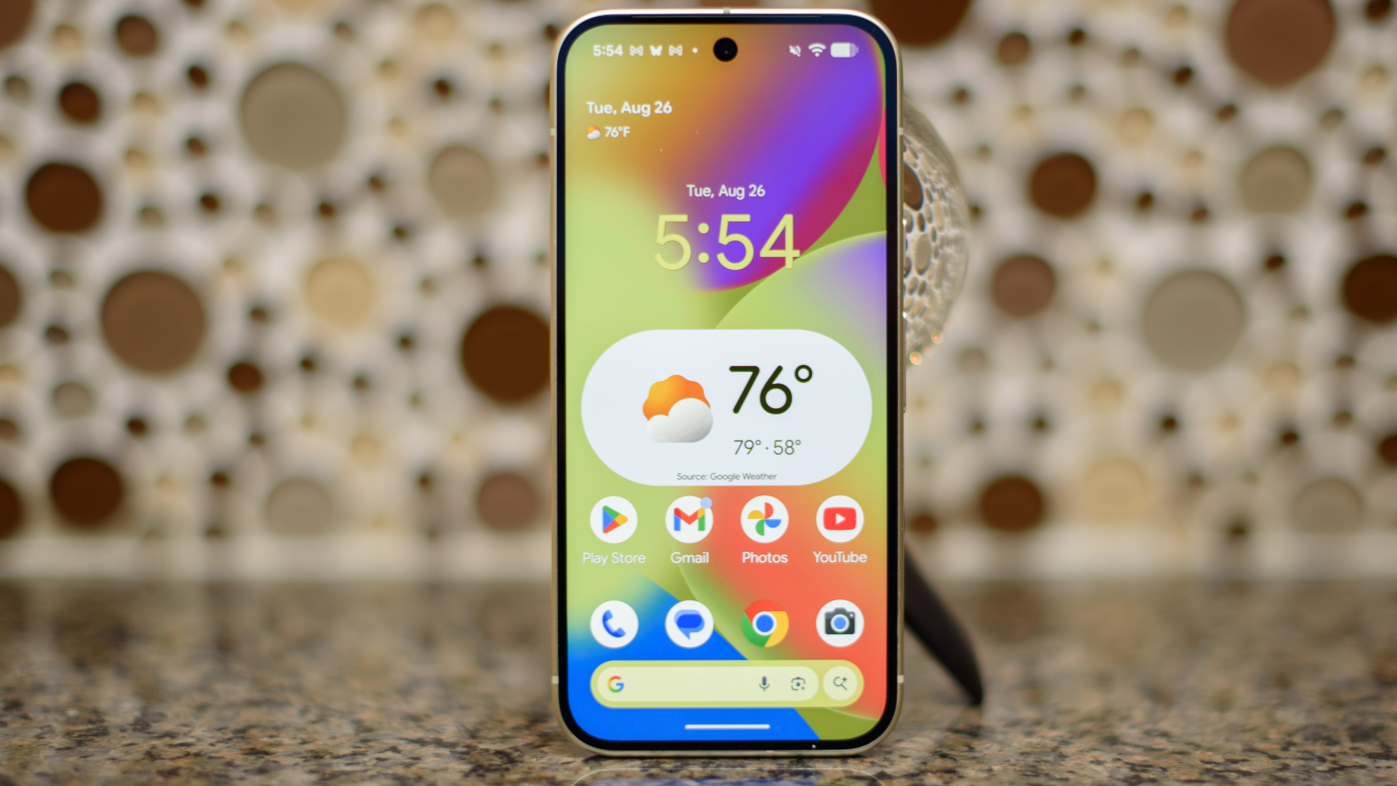Google Pixel 10 in Lemongrass against a sparkling backsplash