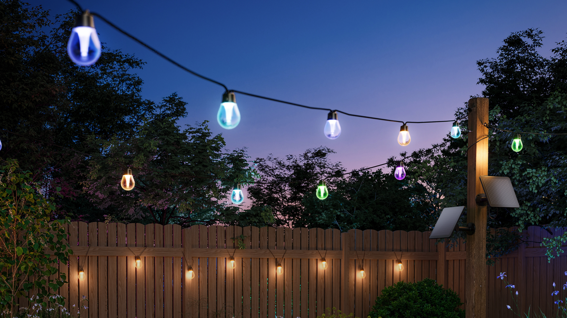 Govee outdoor solar string lights hanging from a line and hanging from a fence at dusk