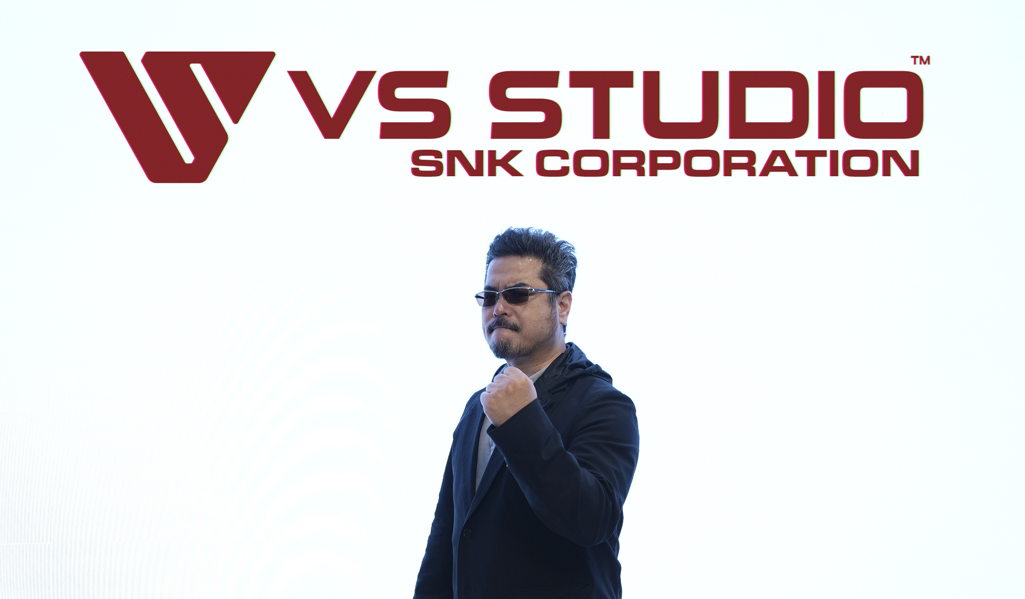 Katsuhiro Harada, CEO of VK Studio, stands in front of the studio logo.