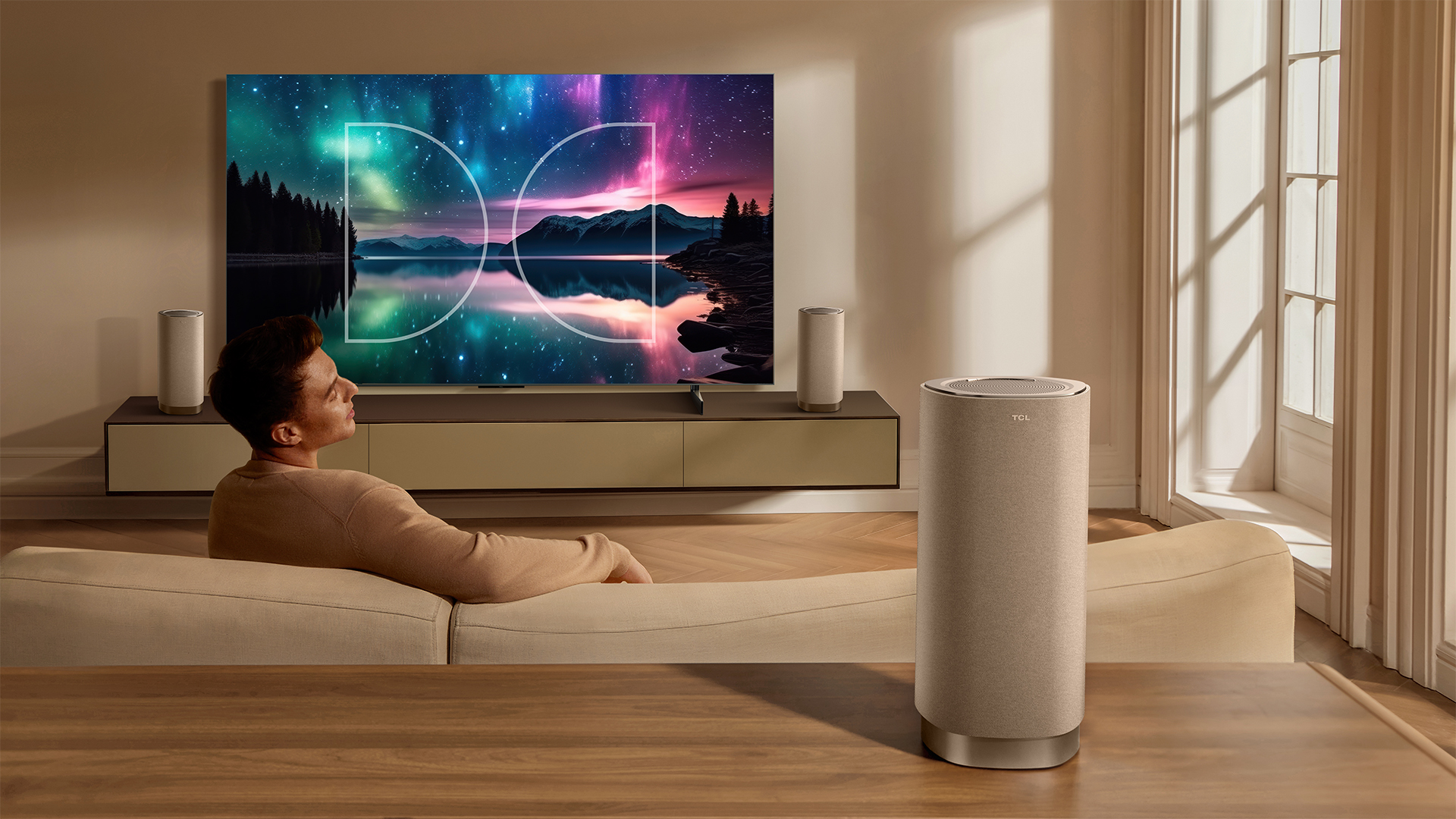 The TCL Z100 speaker behind a man watching television