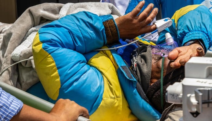 Mountaineer Dawa Sherpa is transported by doctors and rescuers upon his arrival at HAMS hospital in Kathmandu, June 4, 2026. — AFP