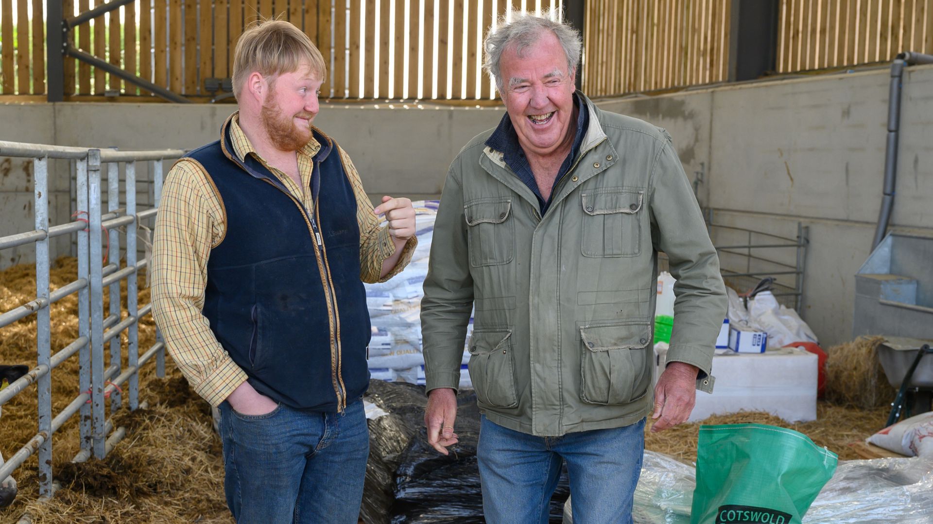 Jeremy and Kaleb laugh in a sheepfold