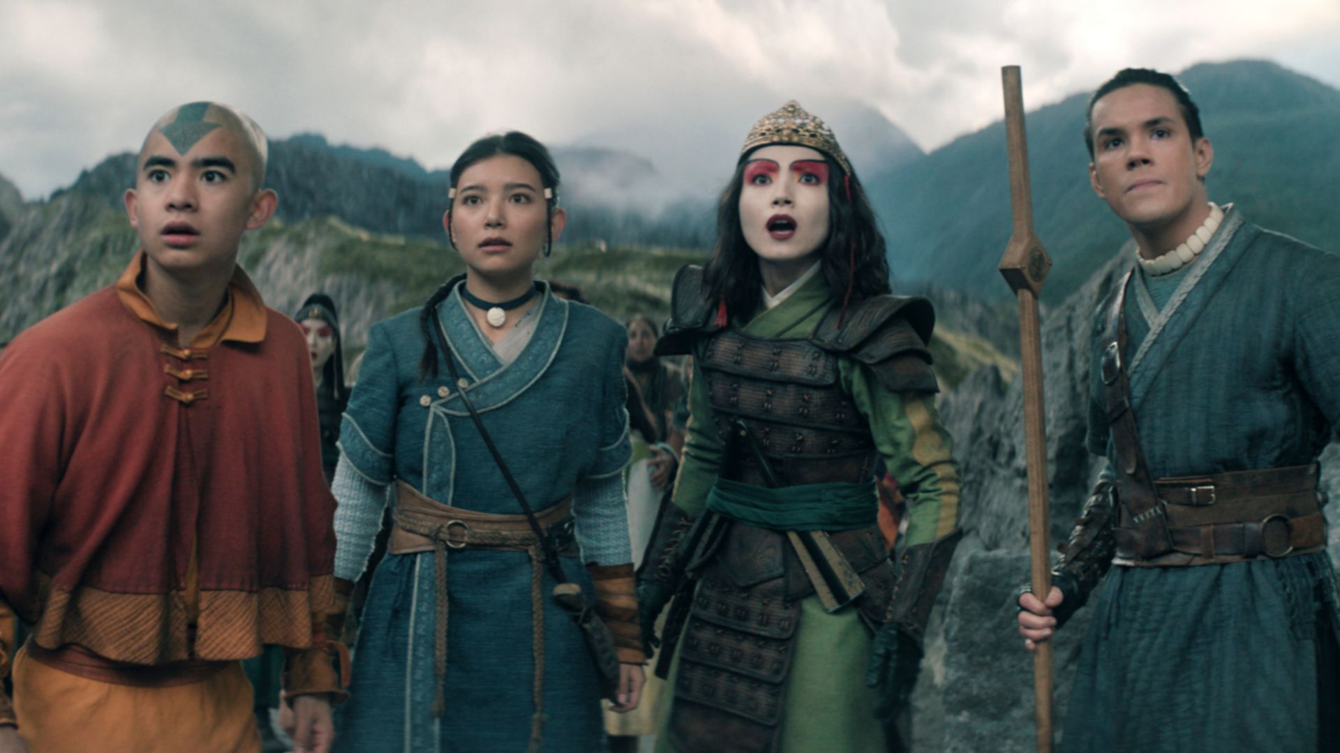 Aang and his friends stand in front of a mountain