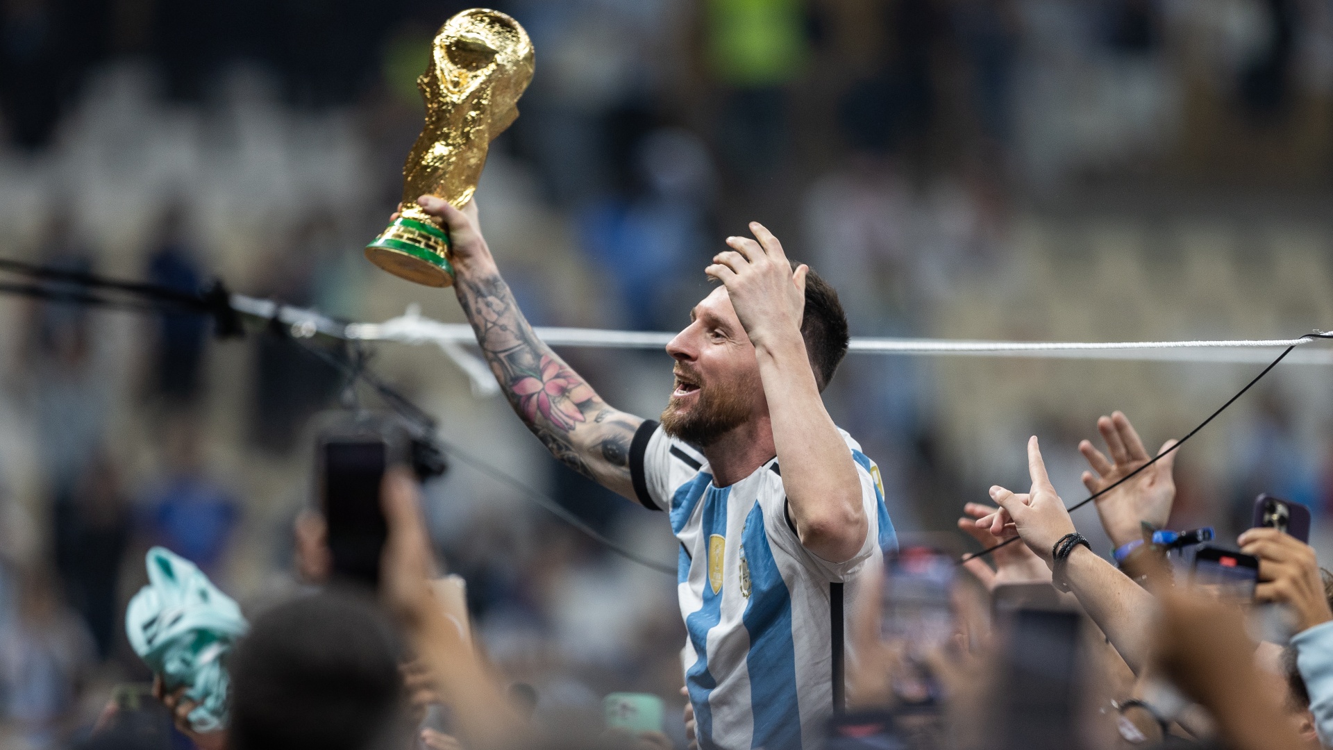 Argentina's Lionel Messi celebrates with the 2022 FIFA World Cup trophy