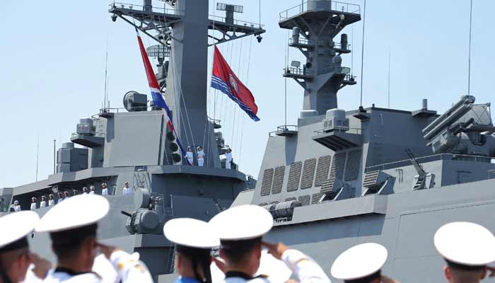 Sailors salute during the commissioning ceremony of the new multi-purpose destroyer Choe Hyon at the port of Nampho, North Korea, June 23, 2026, in this photo released by the North Korean official news agency.