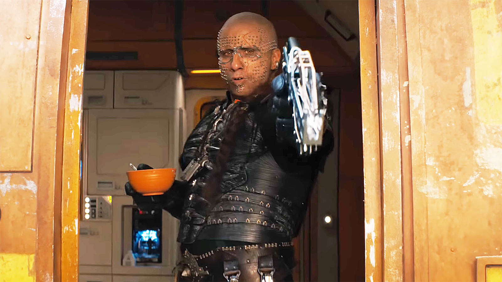 Krem shooting a bolt with his crossbow while standing in a spaceship in Supergirl