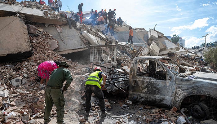 Rescuers and volunteers search for survivors in the rubble of a collapsed building in La Guaira state, Venezuela, June 28, 2026, following earthquakes. -AFP