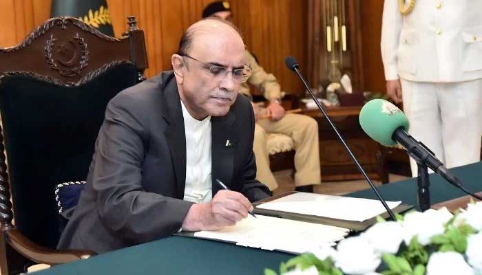President Asif Ali Zardari signs a bill in this undated photo. — President’s House