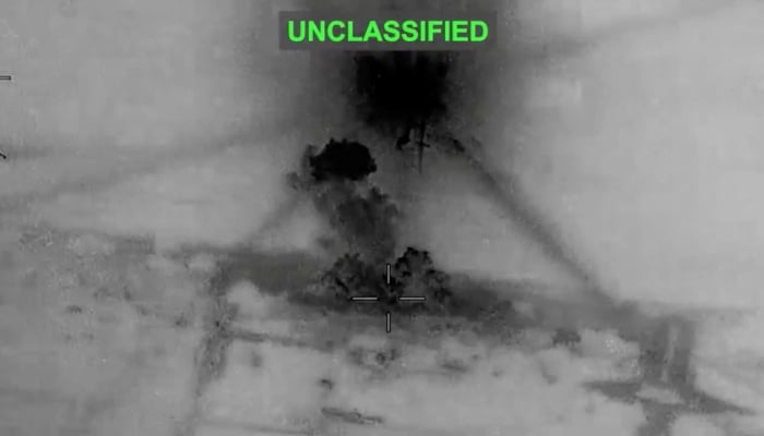 Smoke rises from explosions at an unknown location, following what U.S. Central Command says are strikes against Iran in response to an Iranian drone strike on a cargo ship in the Strait of Hormuz, in this screenshot from video posted June 26, 2026. — Reuters