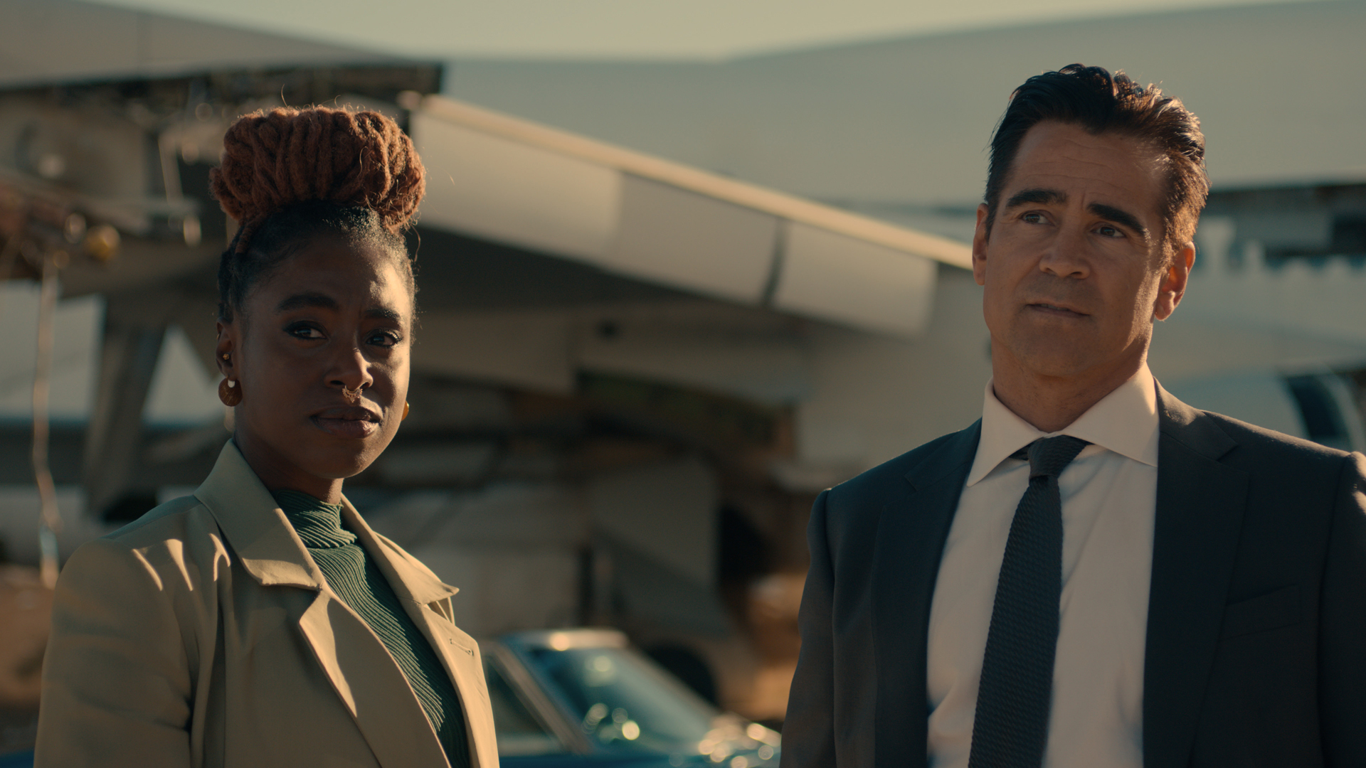 Kirby Howell-Baptiste and Colin Farrell's characters stand side by side in Apple TV Plus. Sugar show