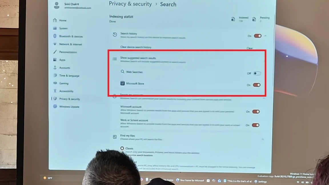 Windows 11 option to disable web search results in Settings, displayed during a meeting on a projector screen