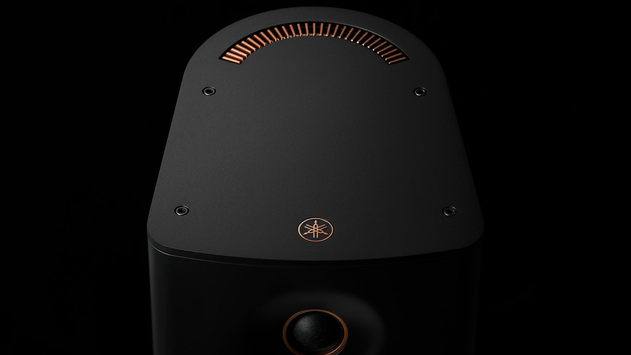 Close-up of Yamaha NX-70A speaker in black, against black background