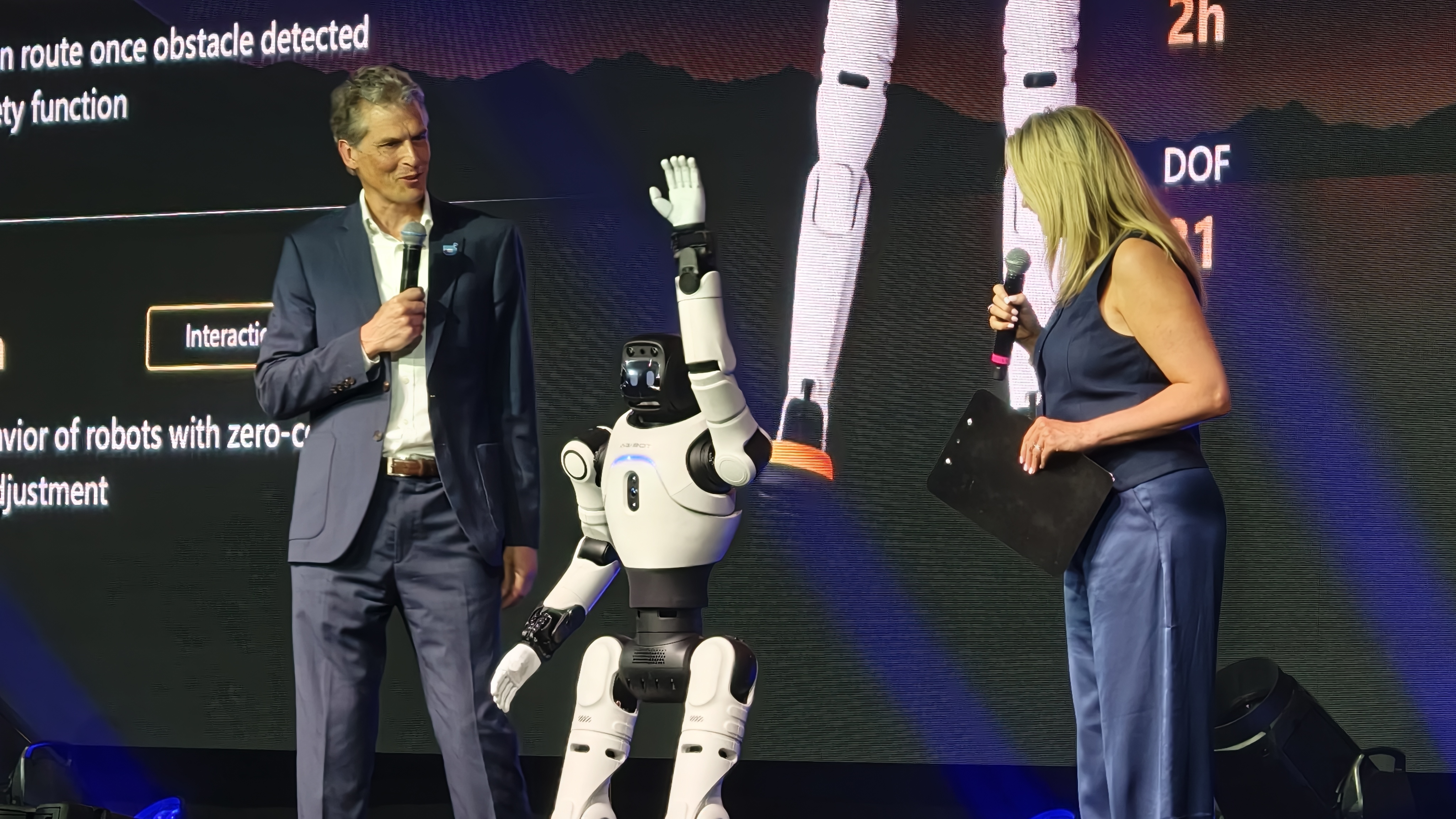 An AGIBOT X2 robot greets the crowd on stage