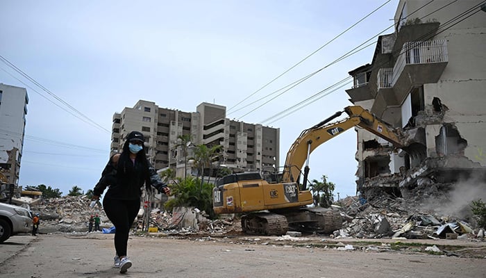 A backhoe demolishes a building in La Guaira, Venezuela, July 4, 2026, following the two June 24 earthquakes. -AFP