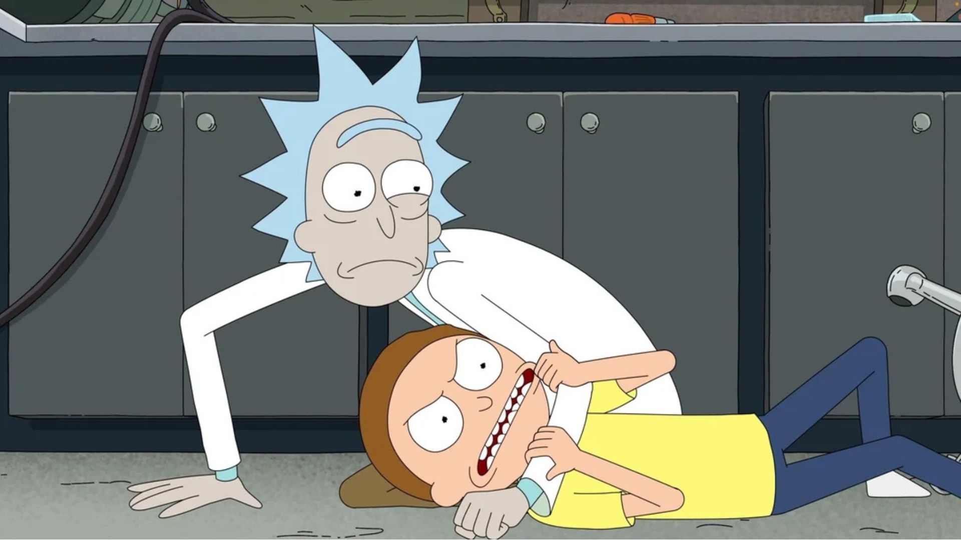 Rick has Morty on the ground in a headlock