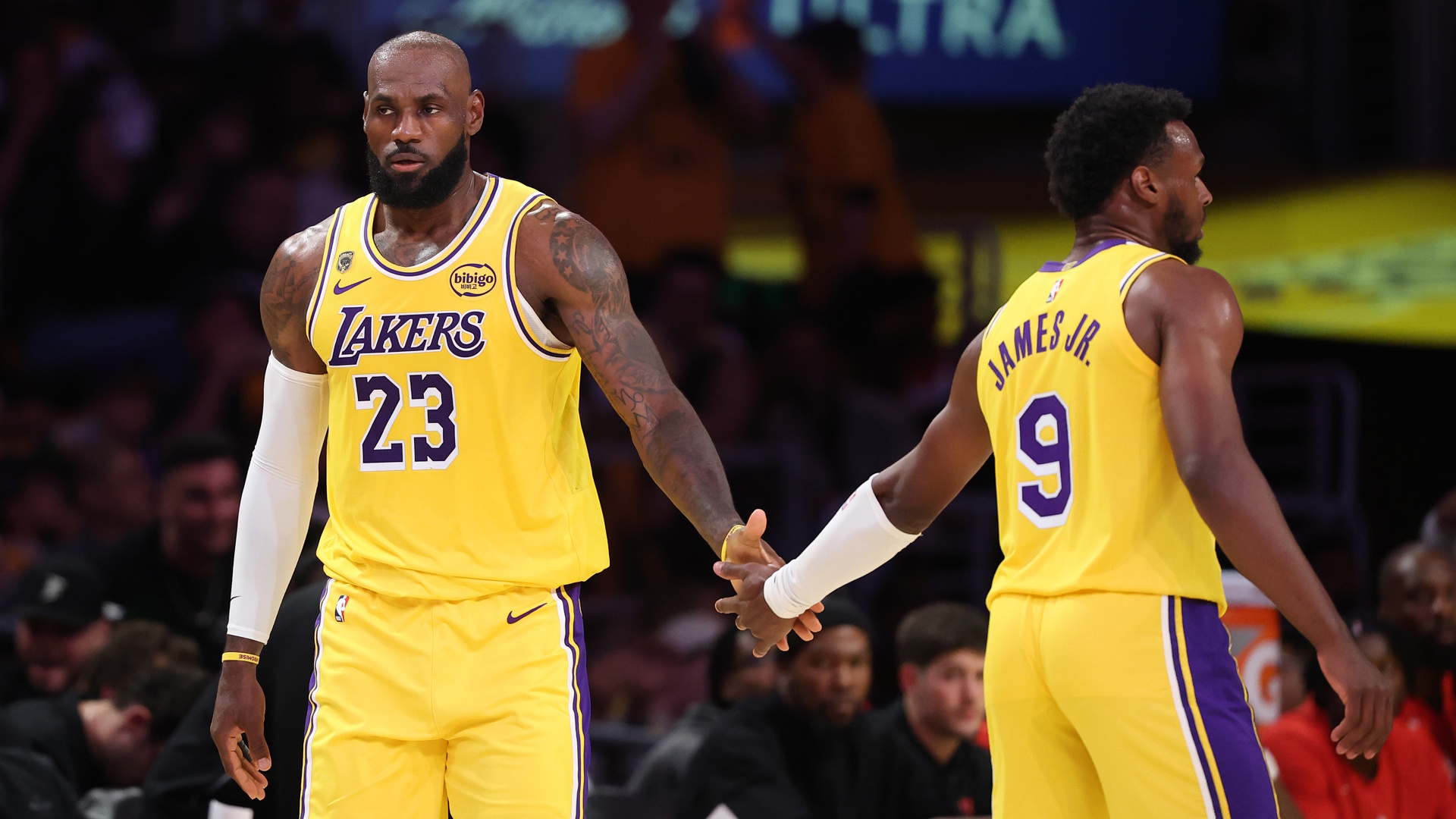 Los Angeles Lakers forward LeBron James is congratulated by his son and teammate of Lakers guard Bronny James during a 2026 NBA Playoffs game.