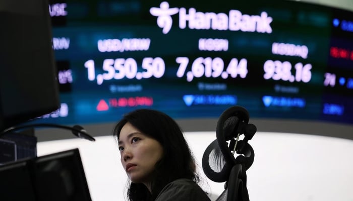 A foreign exchange trader works in front of an electronic board displaying the exchange rate between the U.S. dollar and the South Korean won, the Korea Composite Stock Price Index (KOSPI) and the South Korean won as well as automated quotes from Korean Securities Brokers (KOSDAQ) in the trading floor of a bank in Seoul, South Korea, June 8, 2026. — Reuters