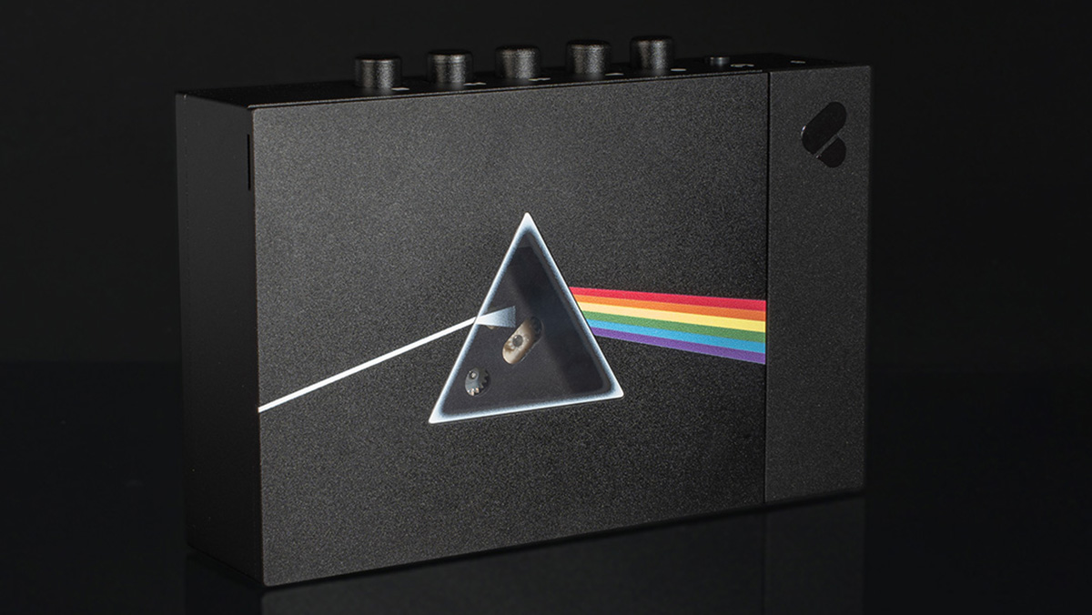 The Pink Floyd x We Are Rewind cassette player showing the Dark Side of the Moon album logo on the front, with a triangular window where the prism would be.
