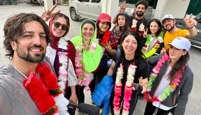 From left to right: Noman Khan, Amina Shabbir, Sohniya Babar, Madeeha Syed, Smell Rose, Noormal Ahmed, Madhu Shala Akhtar, Kamran Khan, Mehrosh Akhtar and Samar Khan after returning to Chitral. - Journalist