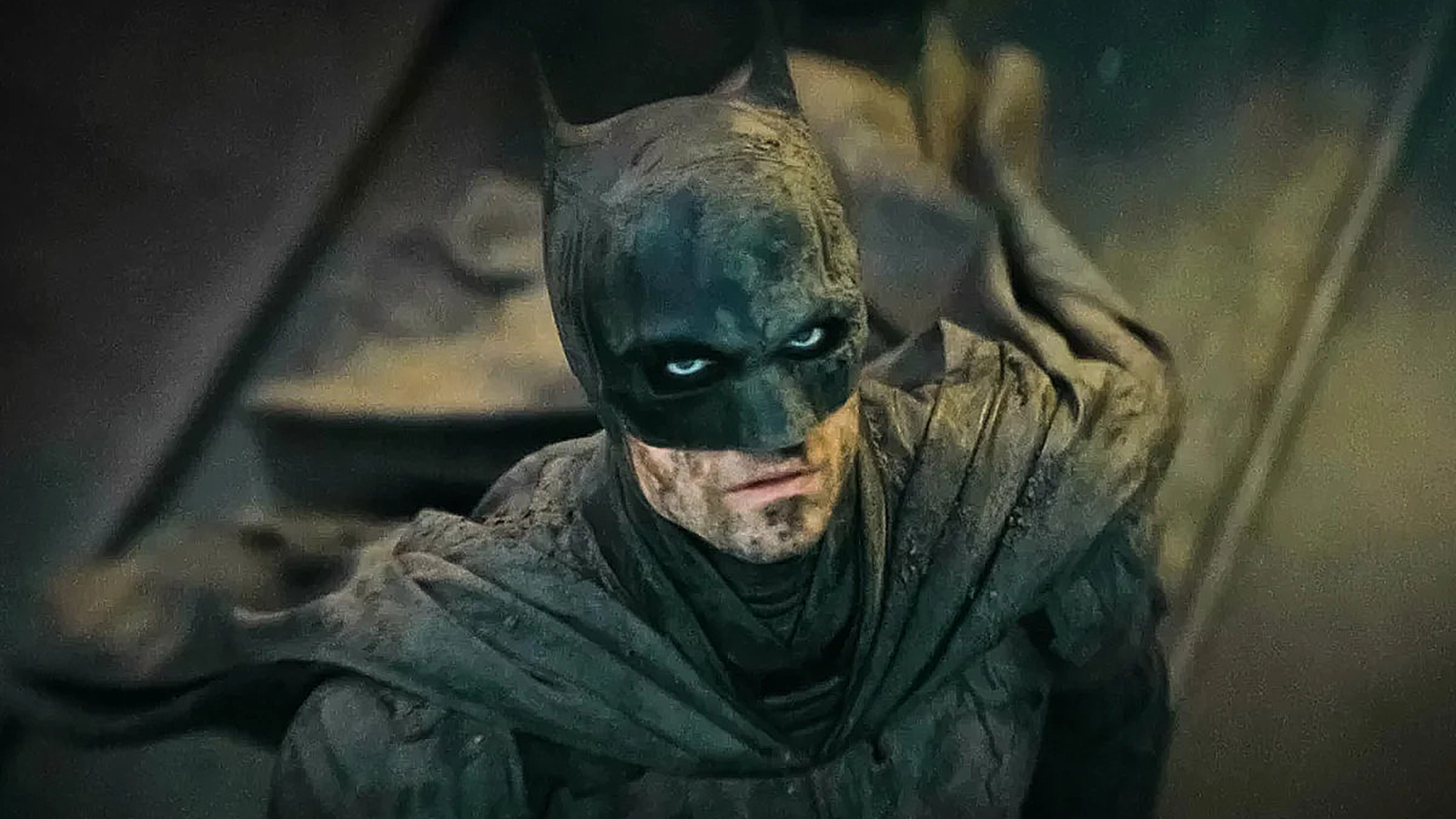 Robert Pattinson's mud-covered Caped Crusader looks up in The Batman