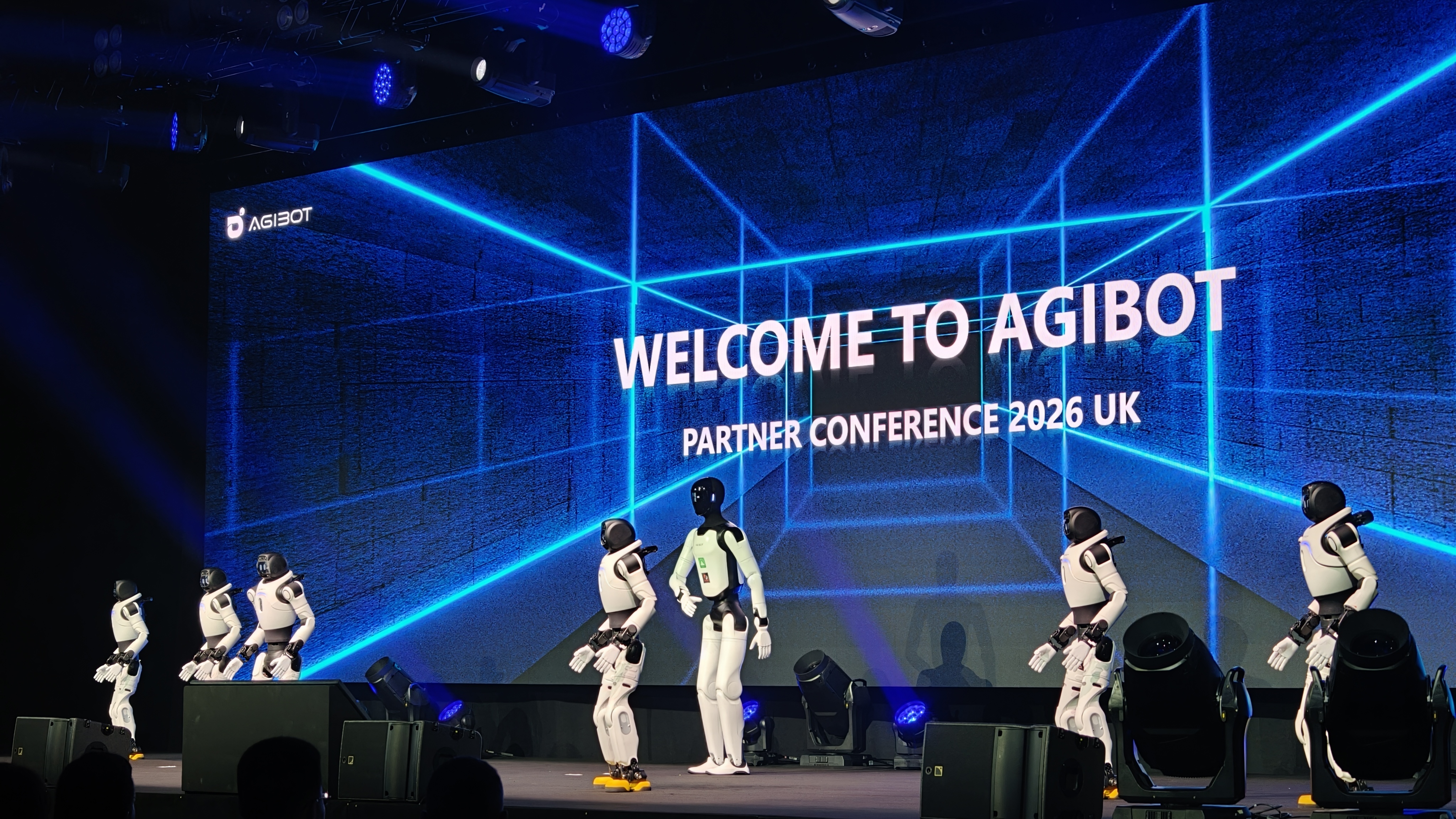 An AGIBOT A3 and several X2 units on stage