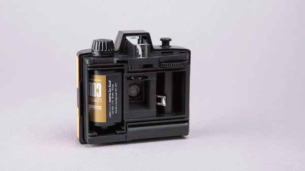 Animation of the Lomography single-use rechargeable half-frame camera with open back and different rolls of film being loaded