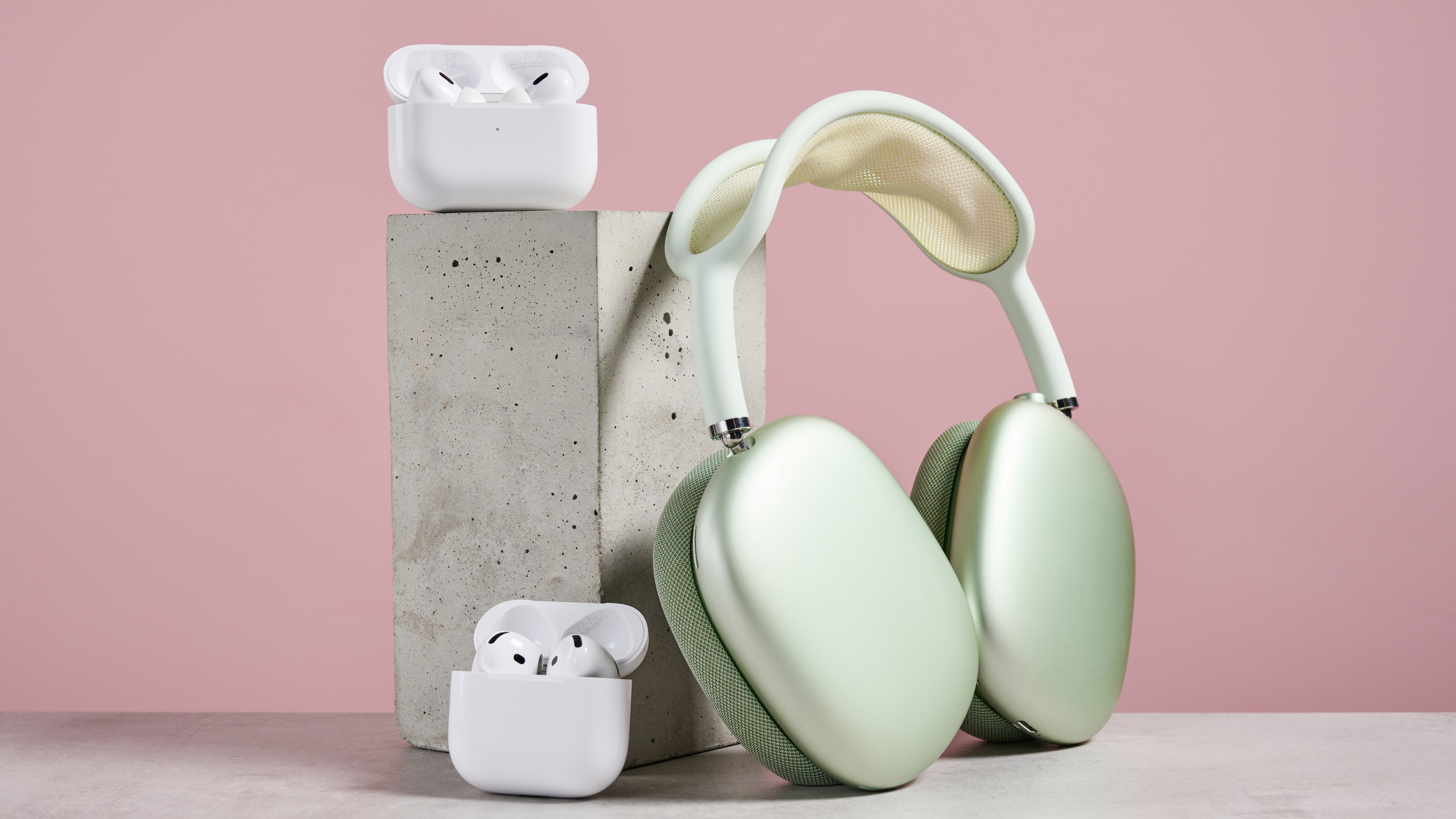 AirPods Pro 2, AirPods 4, and AirPods Max arranged together on a desk